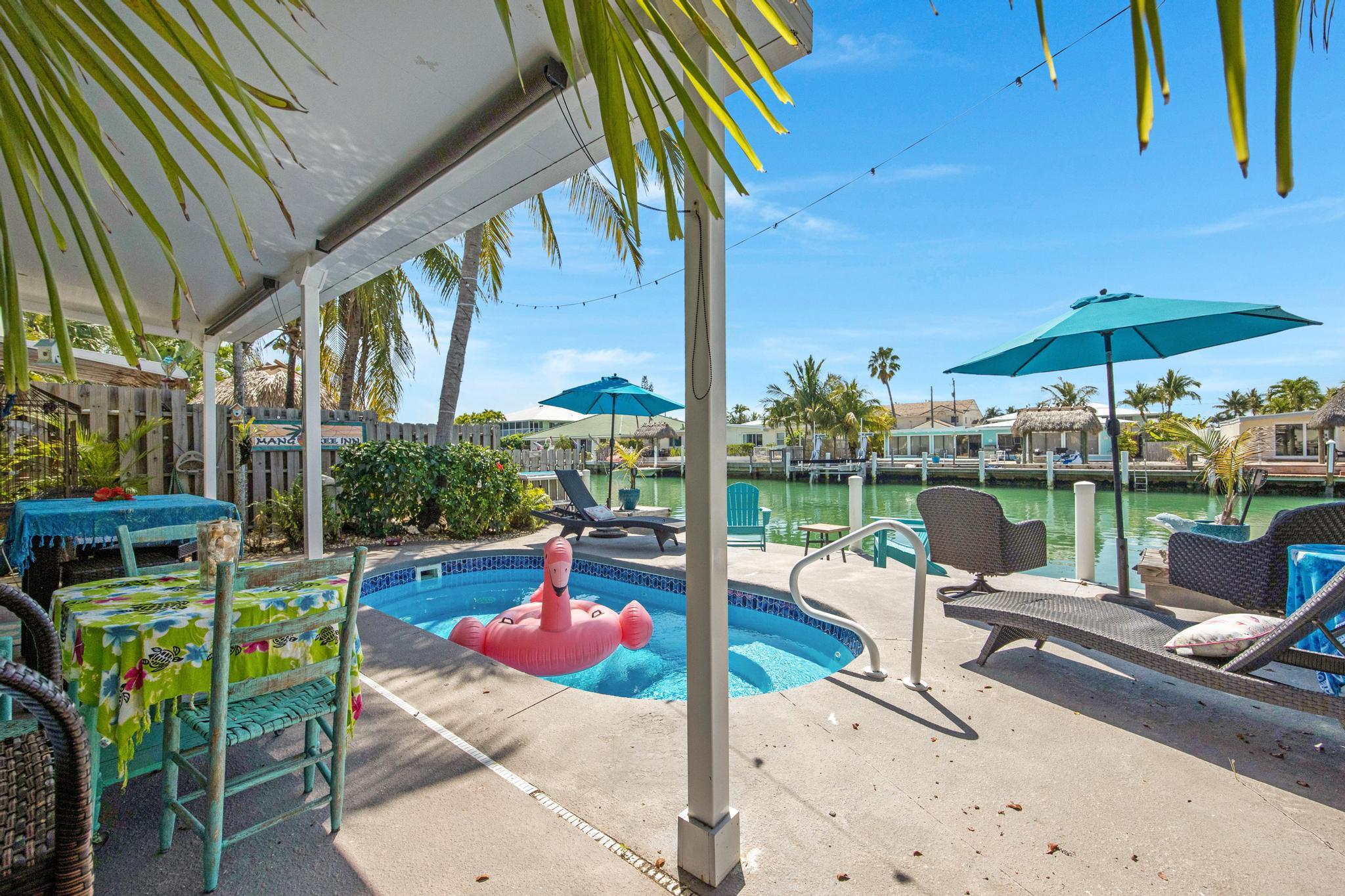 351 8th Street Key Colony Beach, FL 33051 - Photo 1 of 38 a view of a patio with a table chairs and backyard