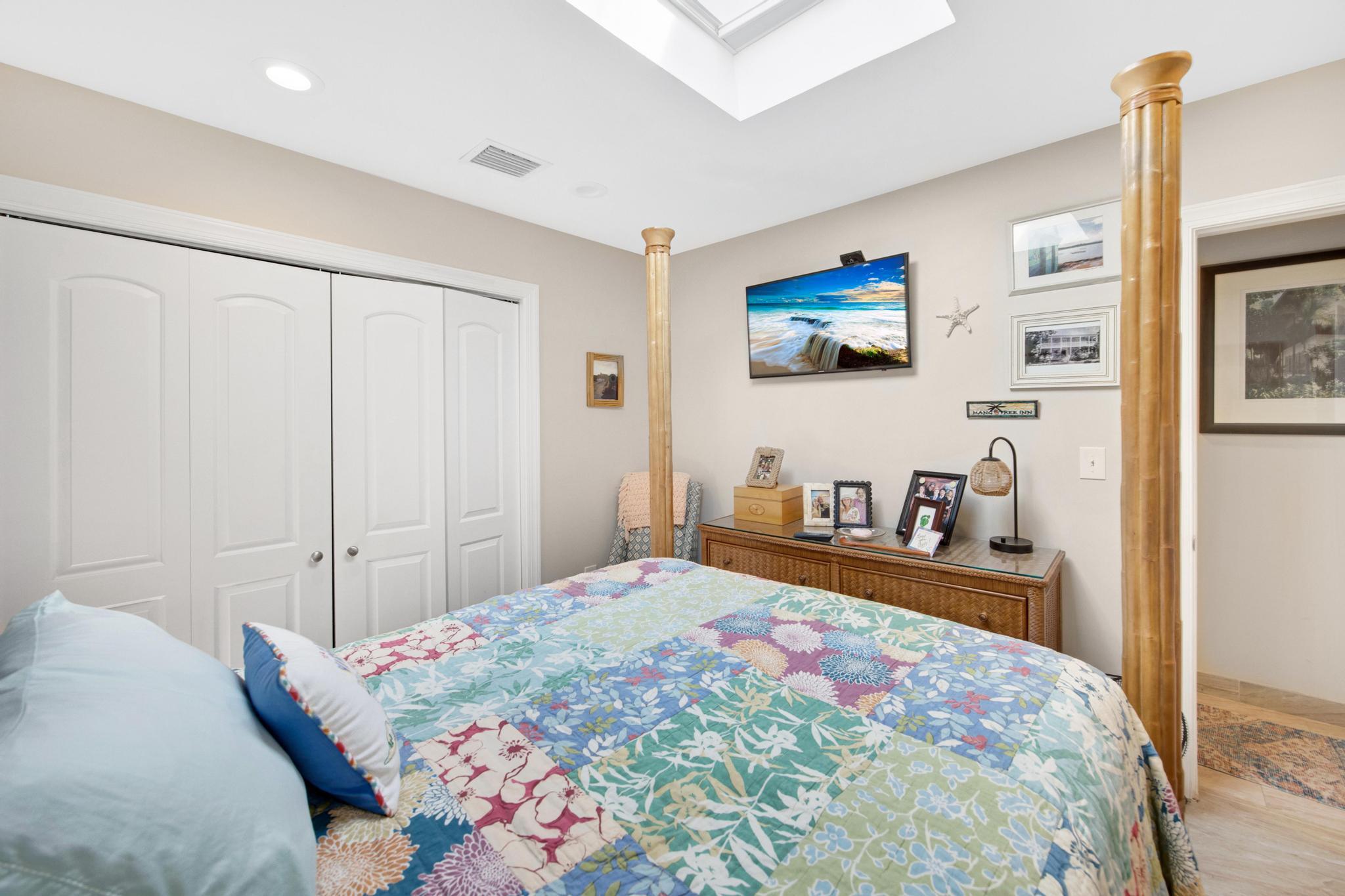 351 8th Street Key Colony Beach, FL 33051 - Photo 15 of 38 a bedroom with a bed and a dresser with wooden floor