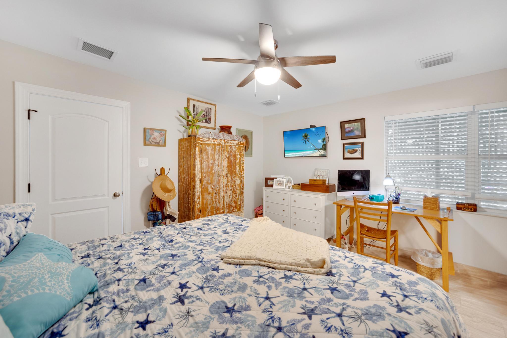 351 8th Street Key Colony Beach, FL 33051 - Photo 24 of 38 a bedroom with a bed and wooden floor