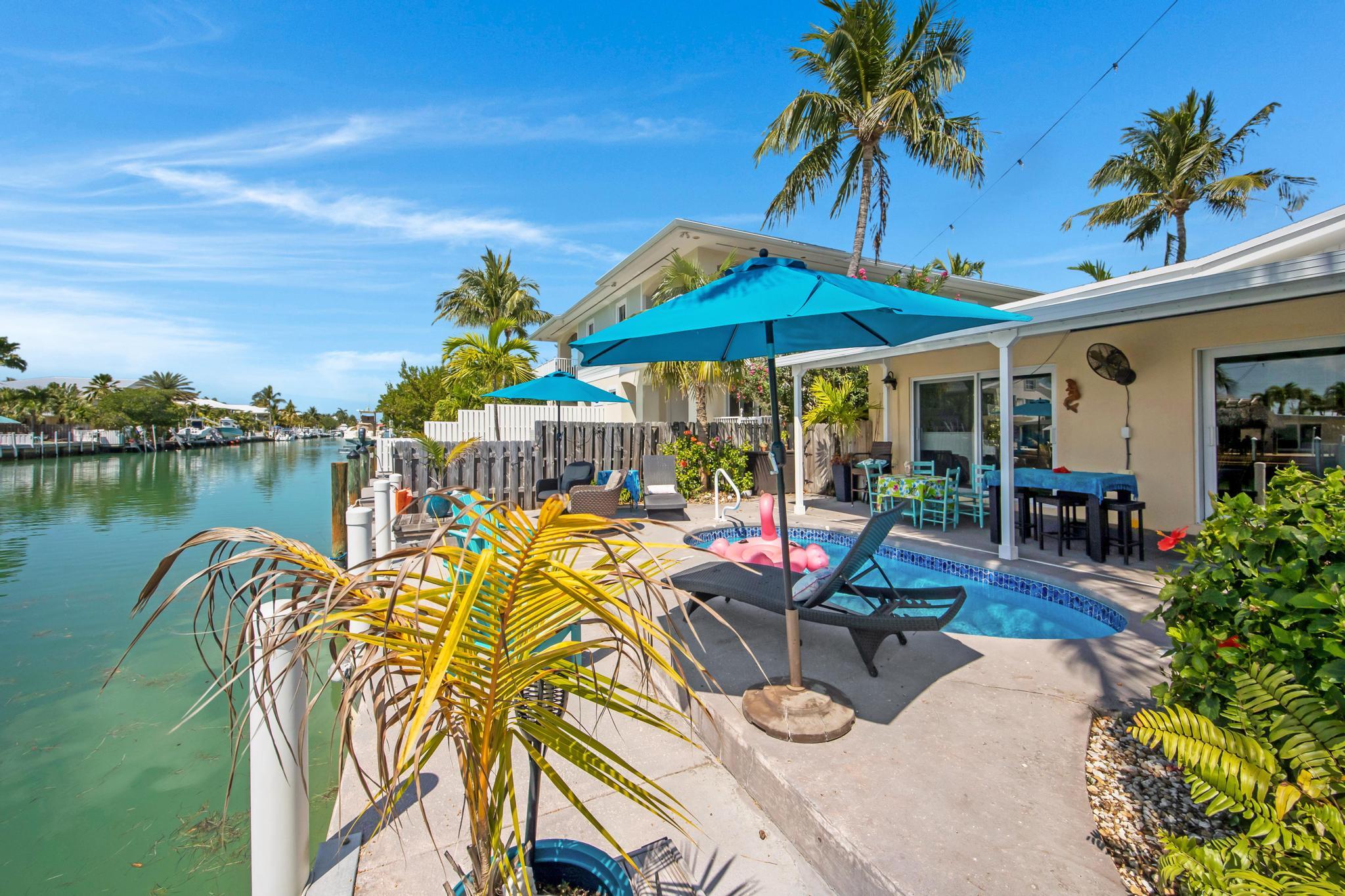 351 8th Street Key Colony Beach, FL 33051 - Photo 33 of 38 a view of a chairs and table in patio with a lake view