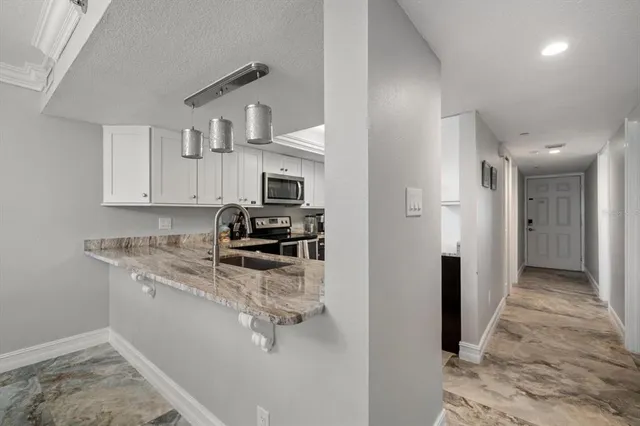 a front view of multi story residential apartment building with yard and entryway