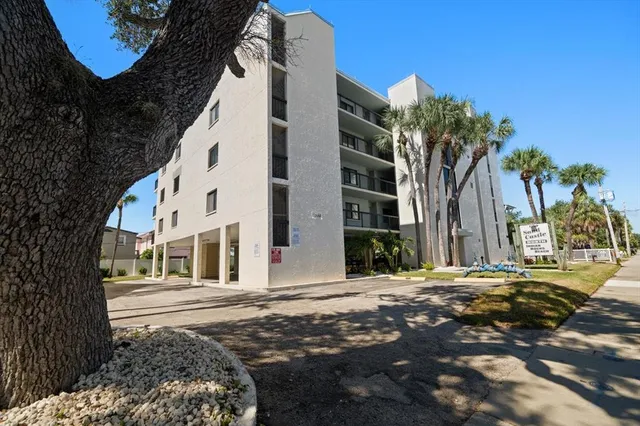 a living room with furniture a dining table and a chandelier