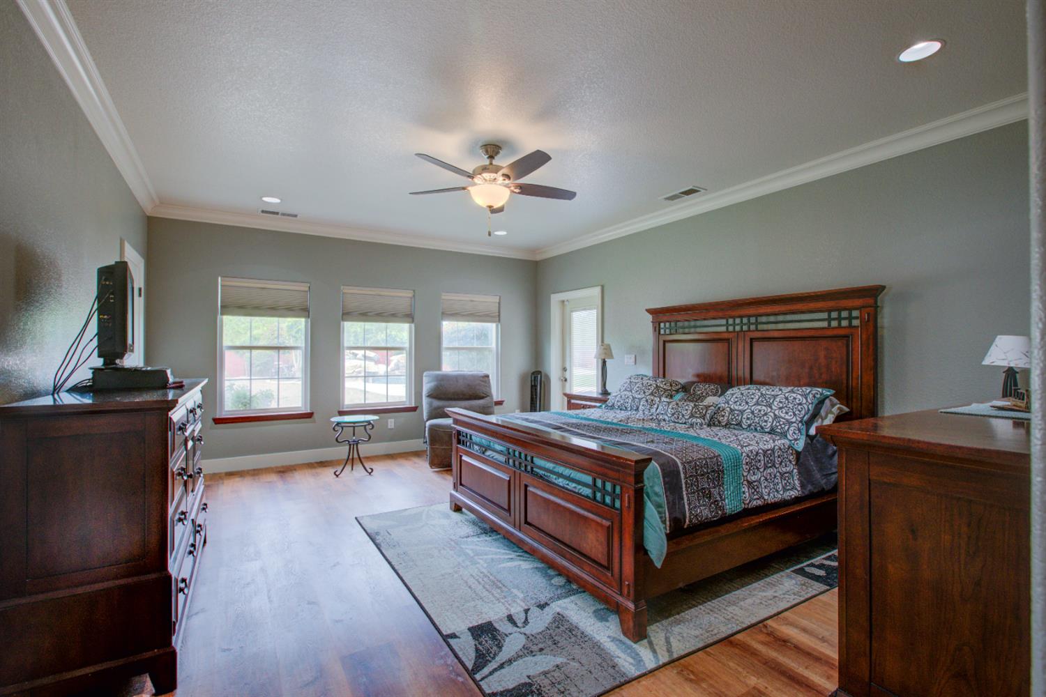 1054 Townhill Road Oakdale, CA 95361 - Photo 28 of 60 a bedroom with a bed and wooden floor