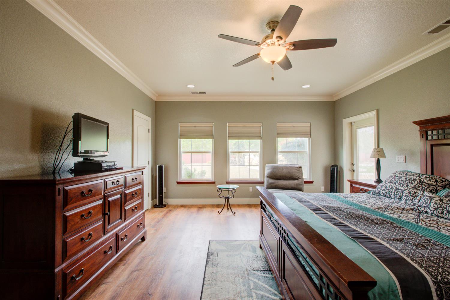 1054 Townhill Road Oakdale, CA 95361 - Photo 29 of 60 a large bedroom with a bed and wooden floor