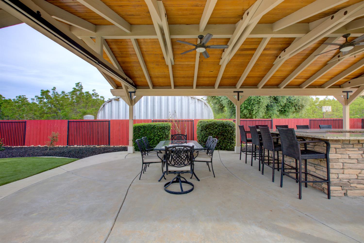 1054 Townhill Road Oakdale, CA 95361 - Photo 44 of 60 a view of patio with table and chairs under an umbrella with a small yard