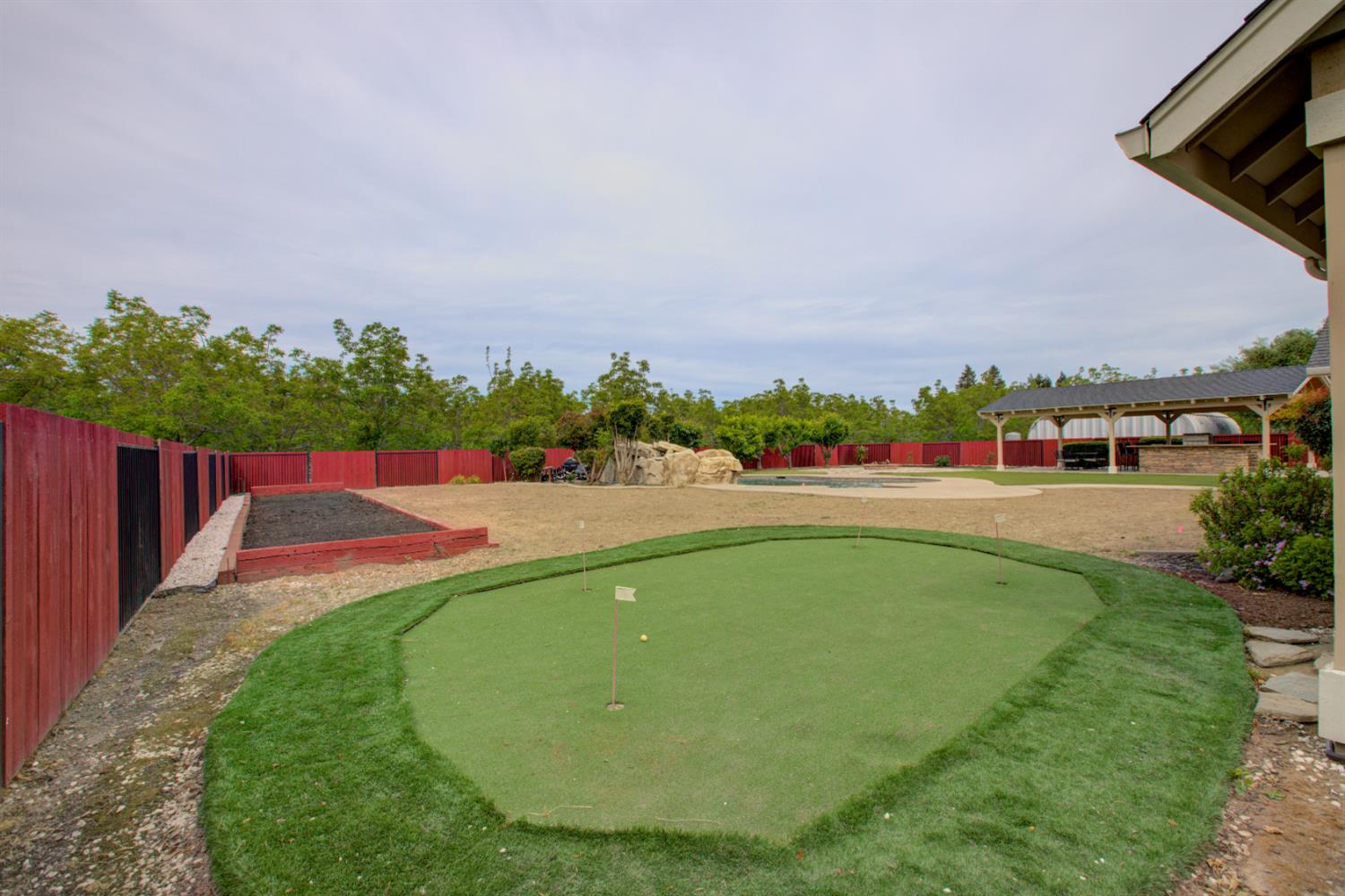 1054 Townhill Road Oakdale, CA 95361 - Photo 54 of 60 a view of a swimming pool with an outdoor seating and a garden
