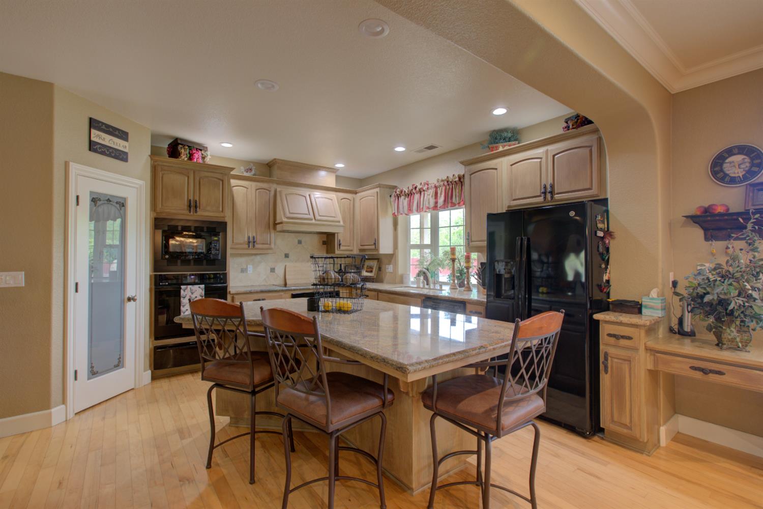 1054 Townhill Road Oakdale, CA 95361 - Photo 7 of 60 a dining area with stainless steel appliances kitchen island granite countertop a dining table chairs and a refrigerator