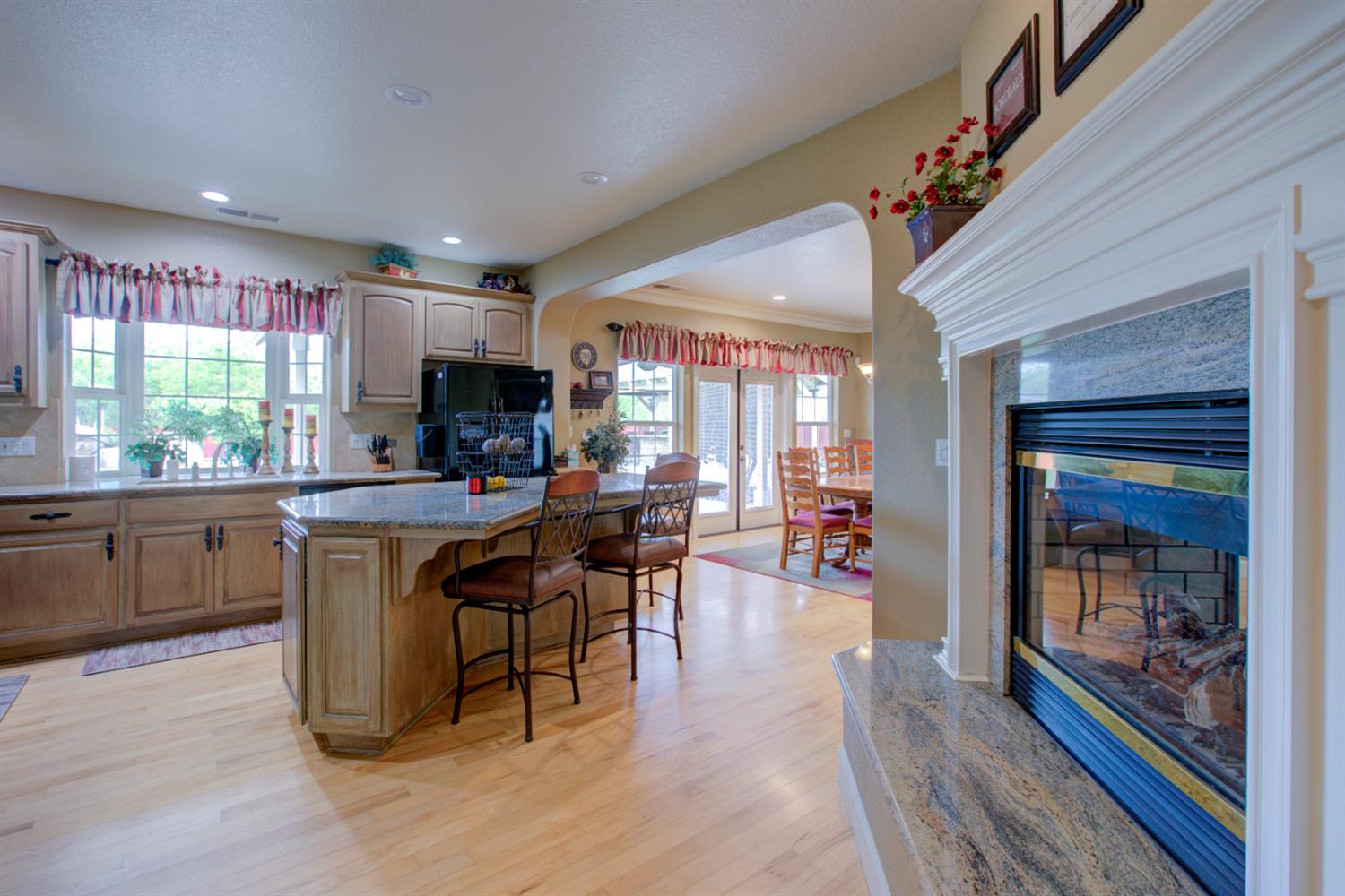 1054 Townhill Road Oakdale, CA 95361 - Photo 8 of 60 a kitchen with stainless steel appliances granite countertop a refrigerator a sink dishwasher a dining table and chairs with wooden floor