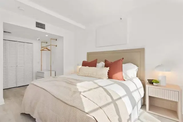 a bedroom with a bed and a lamp