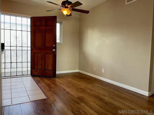 wooden floor in an empty room with a window