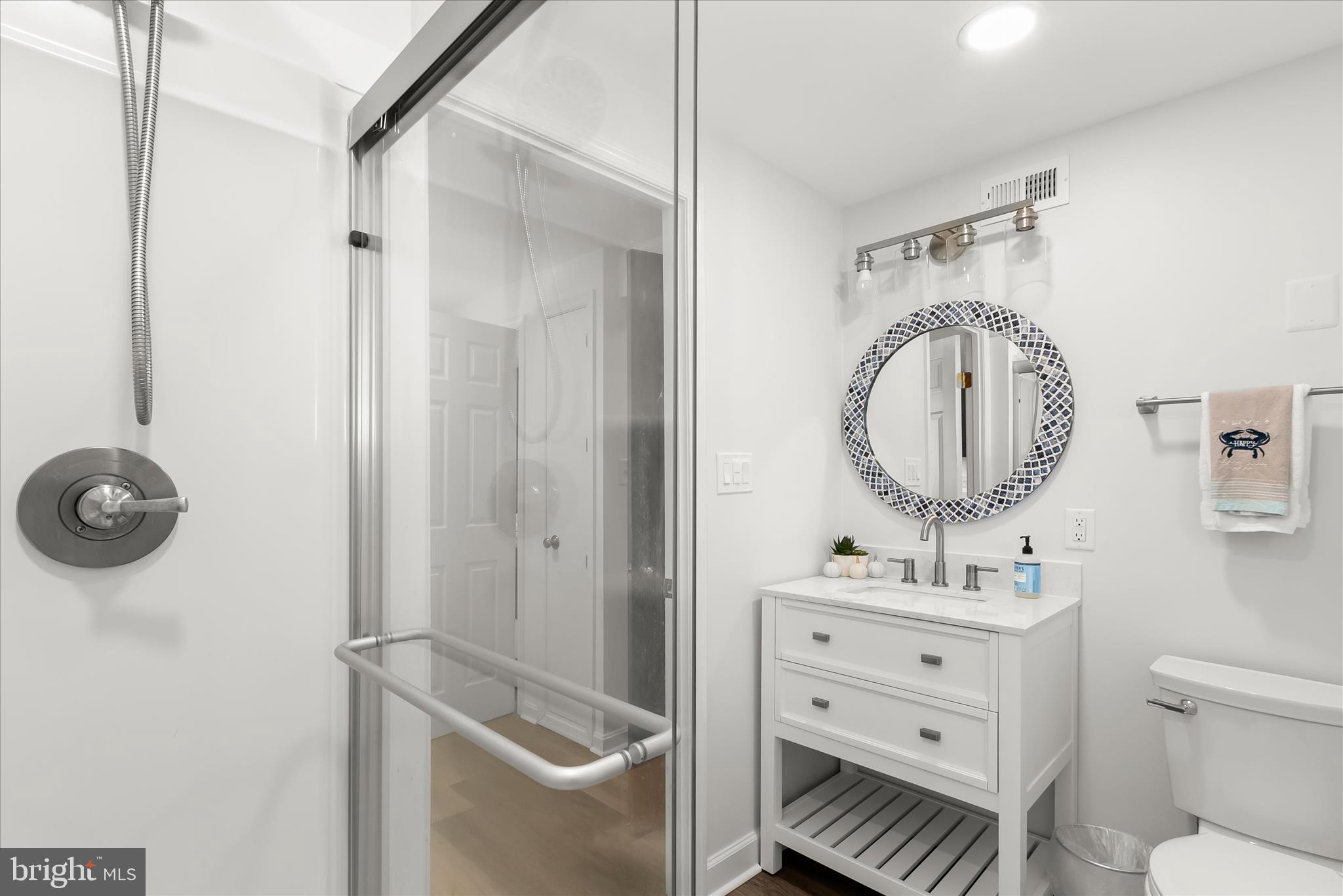 330 South Riverside Drive Crownsville, MD 21032 - Photo 52 of 137 a bathroom with a toilet a sink a mirror and vanity