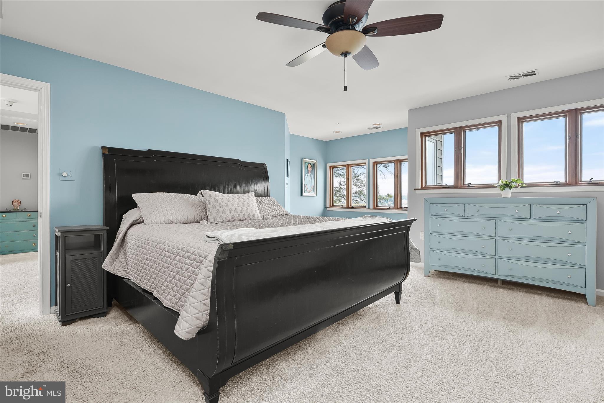 330 South Riverside Drive Crownsville, MD 21032 - Photo 54 of 137 a spacious bedroom with a bed a dresser and a chandelier