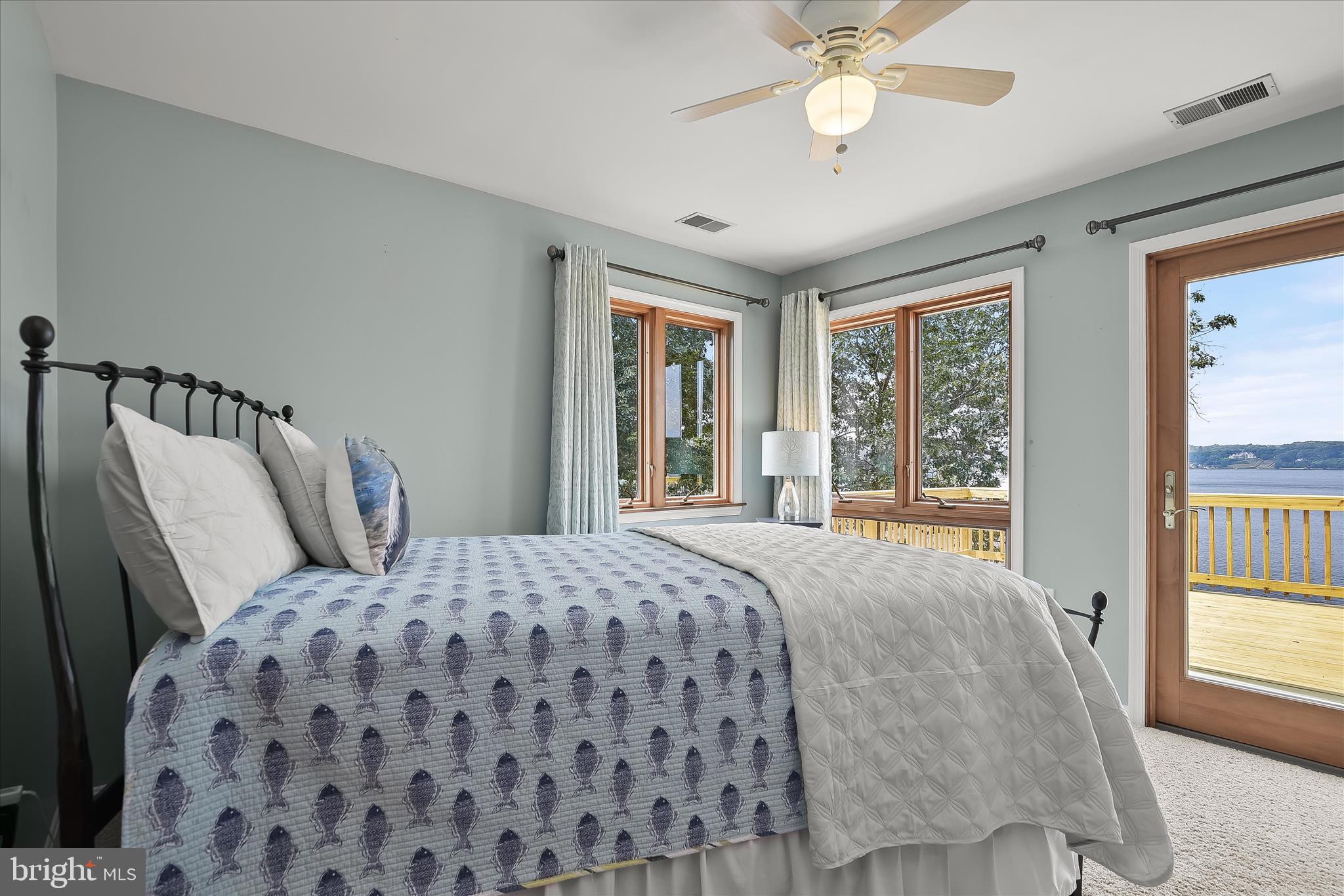330 South Riverside Drive Crownsville, MD 21032 - Photo 65 of 137 a bedroom with a large bed and a chandelier