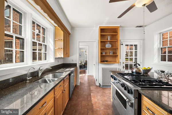 a kitchen with stainless steel appliances granite countertop a stove and a sink