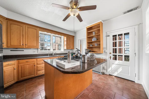 a kitchen with granite countertop a sink stainless steel appliances and cabinets