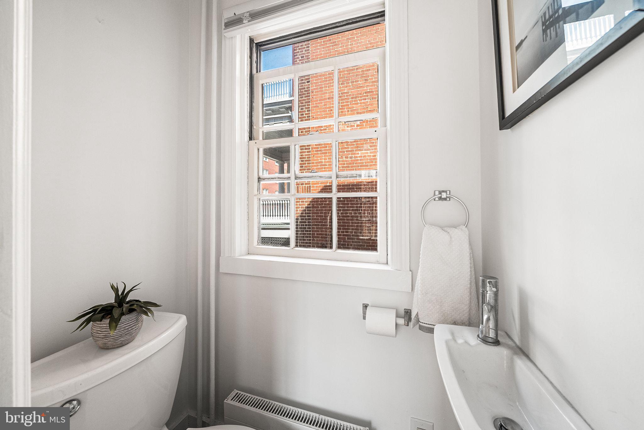 106 North Court Street Frederick, MD 21701 - Photo 13 of 34 a bathroom with a sink a toilet and shower