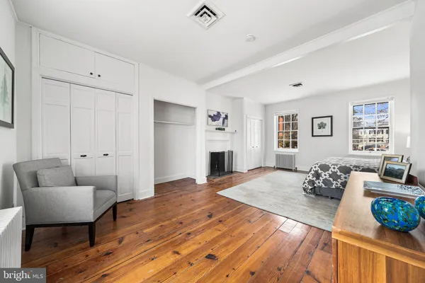a bedroom with a bed and a couch