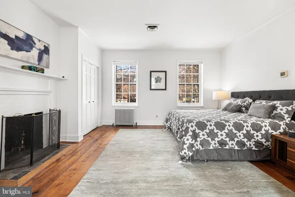 a bedroom with a bed and a fireplace