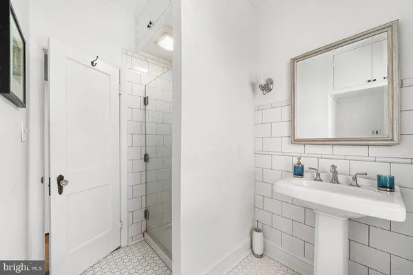 a bathroom with a sink vanity and a mirror