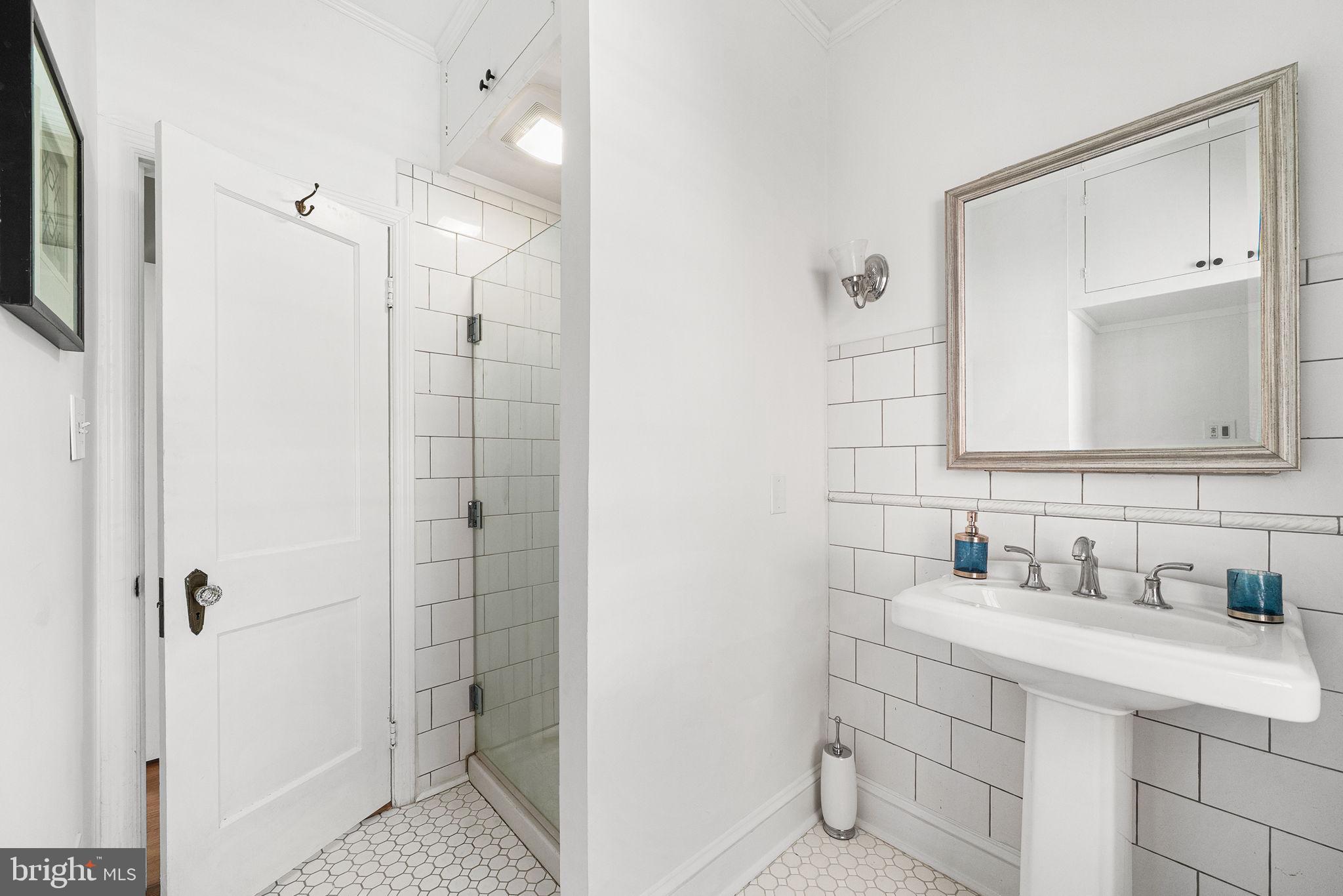 106 North Court Street Frederick, MD 21701 - Photo 19 of 34 a bathroom with a sink vanity and a mirror