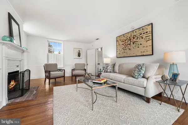 a living room with furniture a fireplace and a table