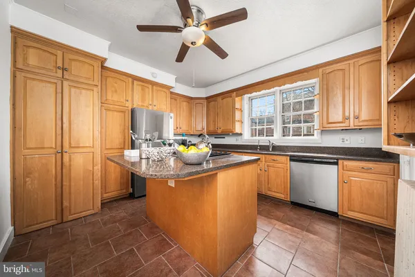 a kitchen with stainless steel appliances granite countertop a sink counter space cabinets and a window