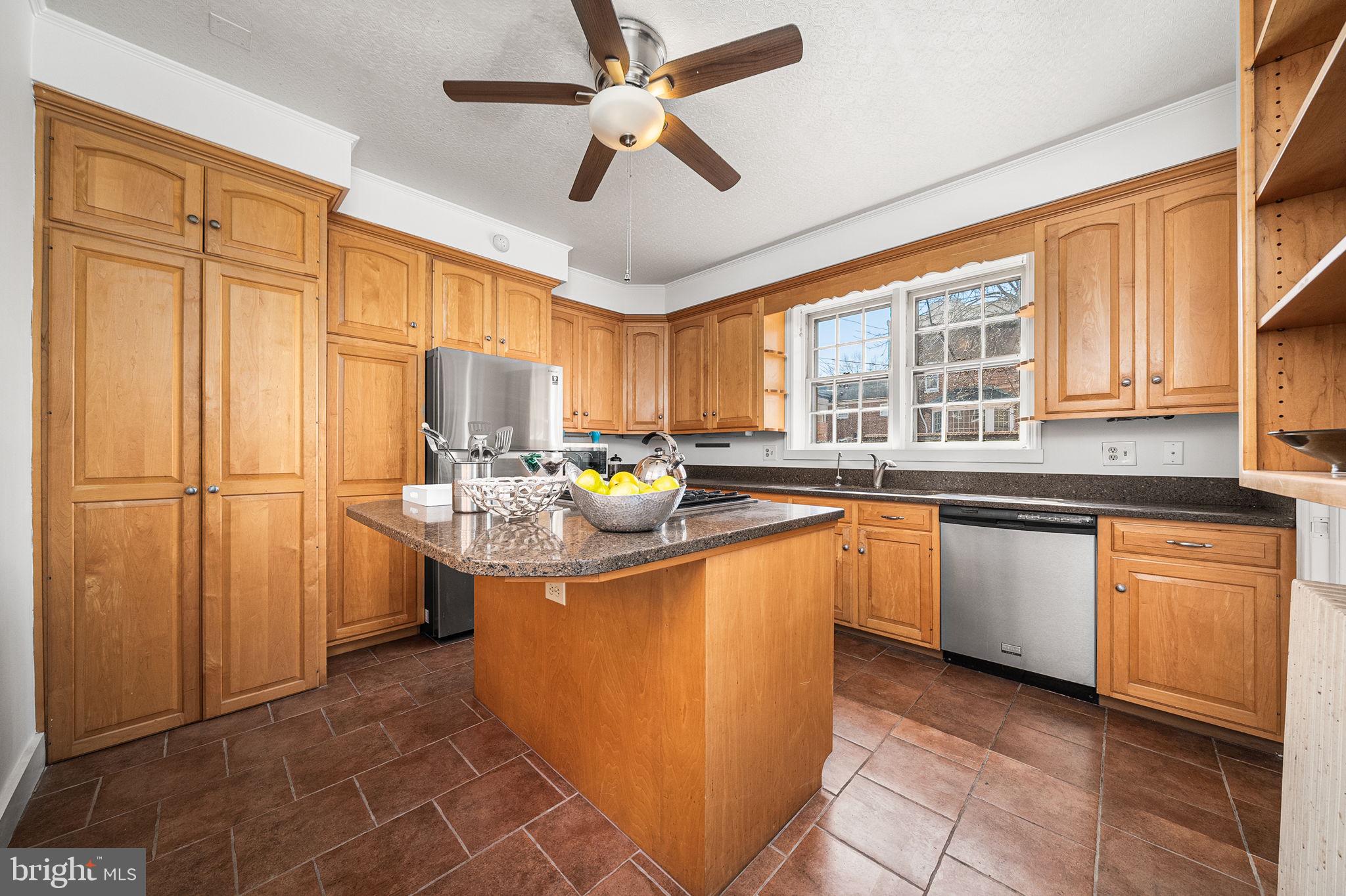 106 North Court Street Frederick, MD 21701 - Photo 10 of 34 a kitchen with stainless steel appliances granite countertop a sink counter space cabinets and a window
