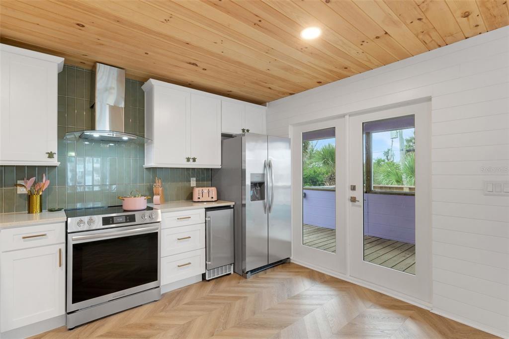 8390 Little Gasparilla Placida, FL 33946 - Photo 11 of 81 a kitchen with stainless steel appliances granite countertop a stove a refrigerator and a sink