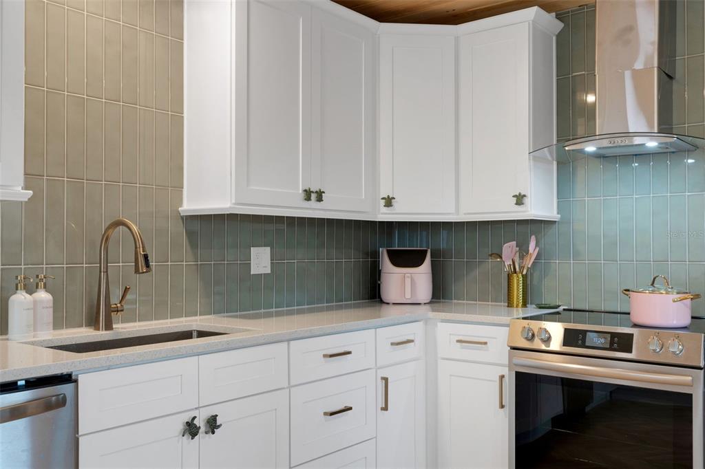 8390 Little Gasparilla Placida, FL 33946 - Photo 18 of 81 a kitchen with granite countertop white cabinets and a stove