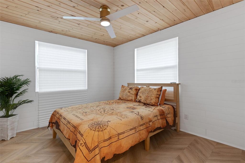 8390 Little Gasparilla Placida, FL 33946 - Photo 26 of 81 a bedroom with a large bed and a chandelier