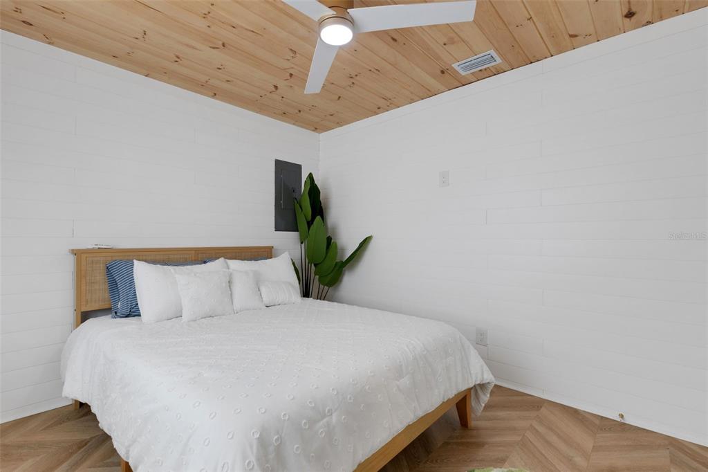 8390 Little Gasparilla Placida, FL 33946 - Photo 31 of 81 a bedroom with a bed and a potted plant