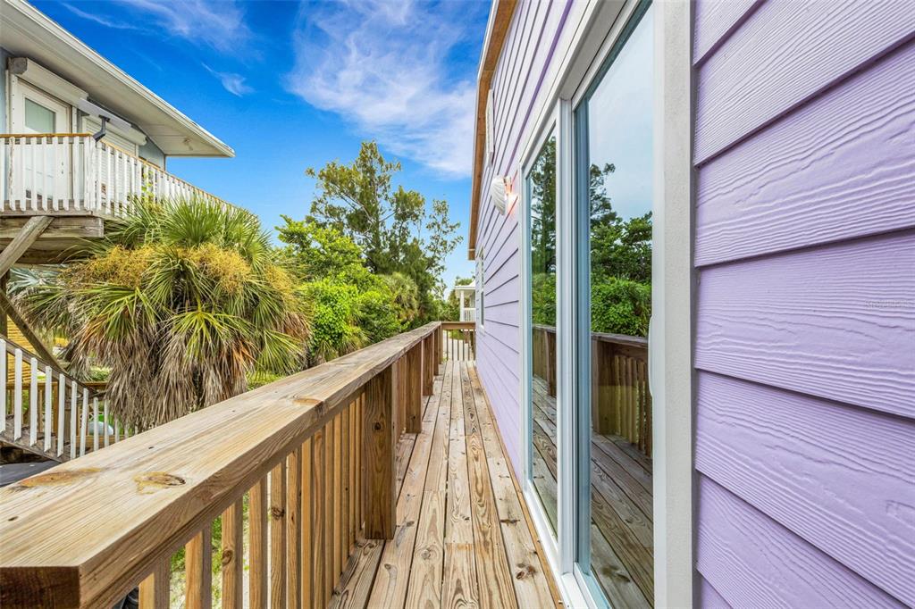 8390 Little Gasparilla Placida, FL 33946 - Photo 41 of 81 a view of a balcony with wooden floor and potted plants