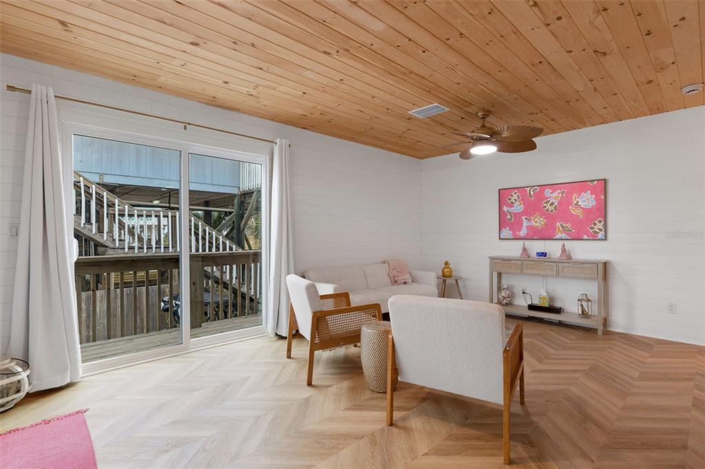 8390 Little Gasparilla Placida, FL 33946 - Photo 6 of 81 a living room with furniture a flat screen tv and a large window