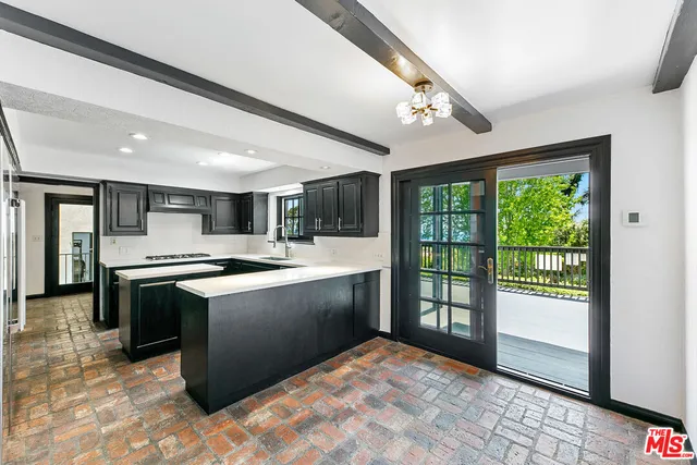 a kitchen with sink cabinets and stainless steel appliances