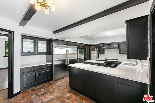 a kitchen that has a sink and a stove in it