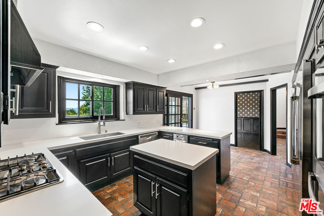 29528 Harvester Road Malibu, CA 90265 - Photo 19 of 36 a kitchen that has a sink and a stove in it