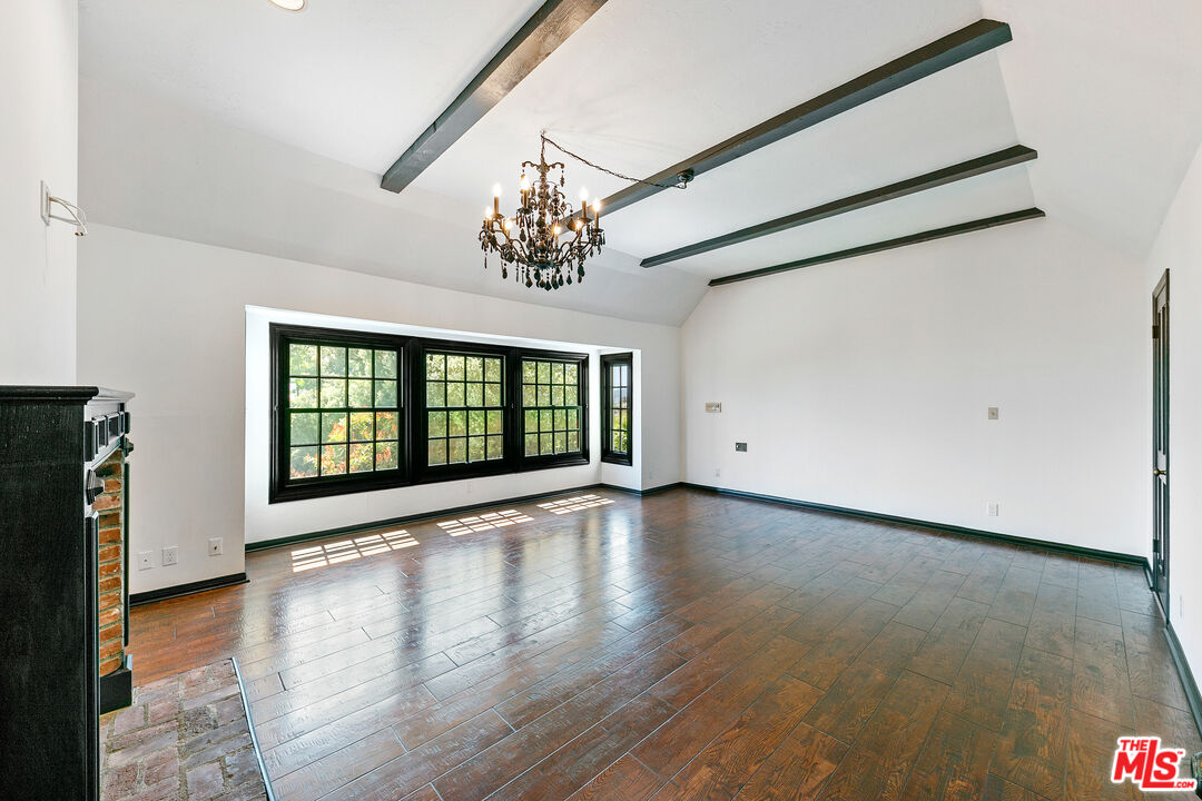 29528 Harvester Road Malibu, CA 90265 - Photo 23 of 36 a view of an empty room with a window and wooden floor
