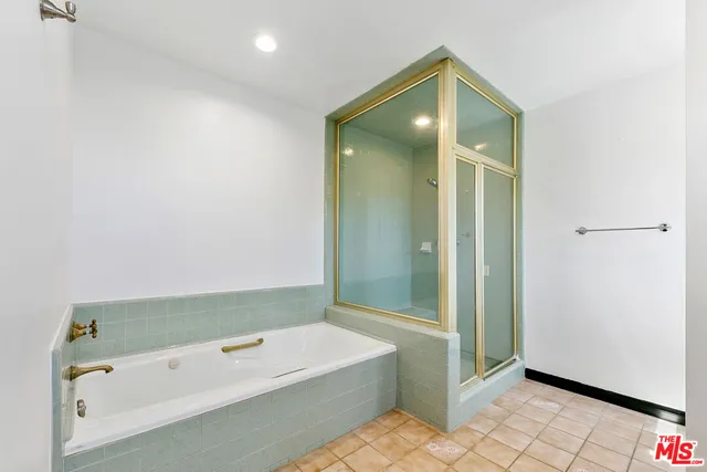 an empty room with wooden floor closet and windows