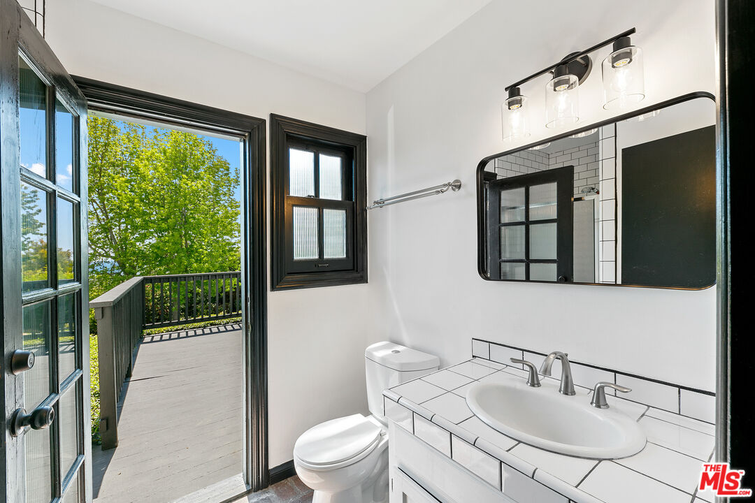 29528 Harvester Road Malibu, CA 90265 - Photo 26 of 41 a bathroom with a sink toilet and a mirror