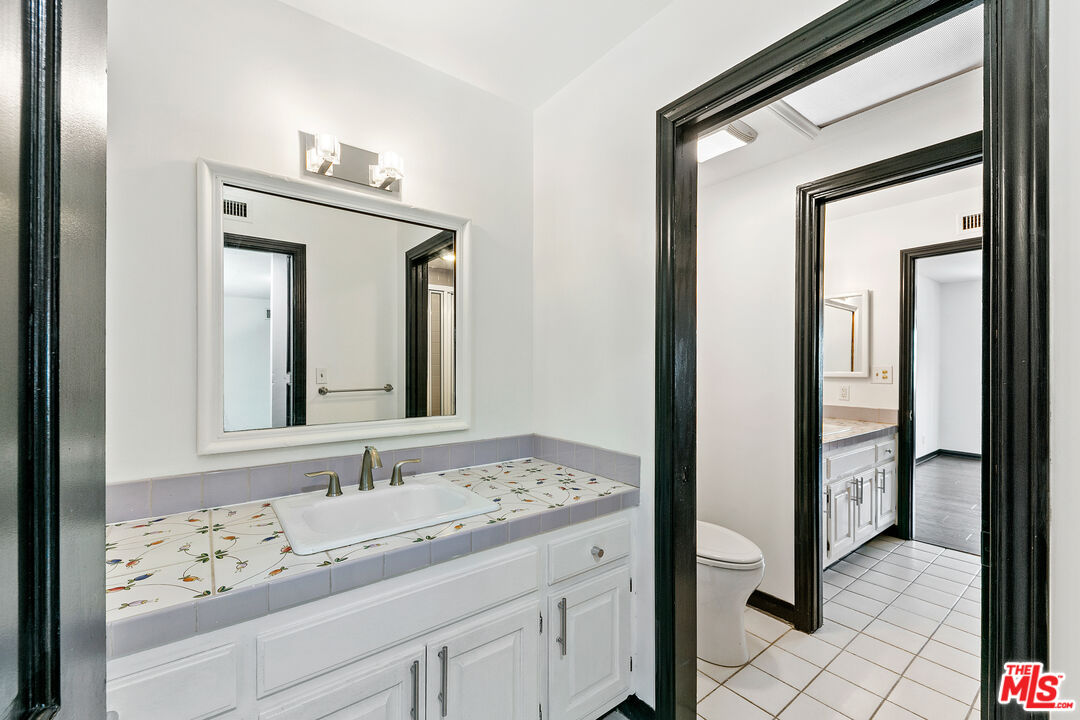 29528 Harvester Road Malibu, CA 90265 - Photo 29 of 36 a bathroom with a sink vanity and mirror