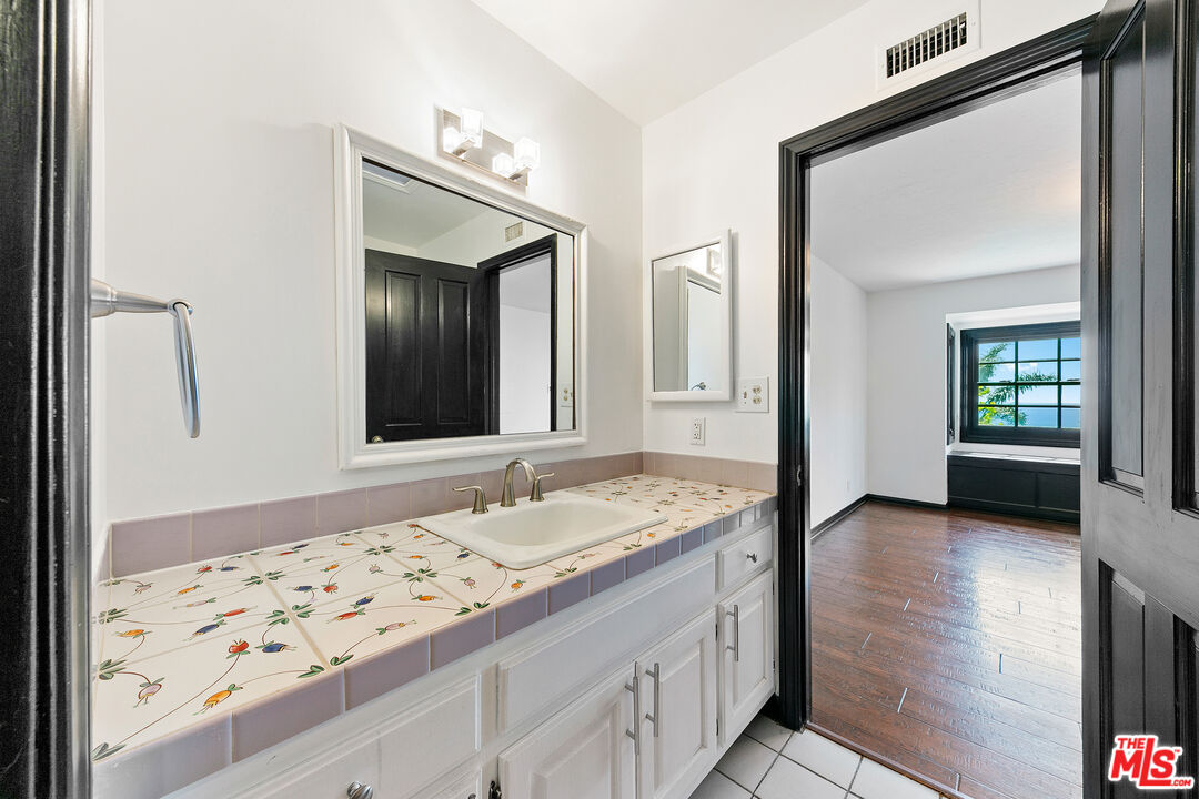 29528 Harvester Road Malibu, CA 90265 - Photo 30 of 36 a bathroom with a sink and a mirror