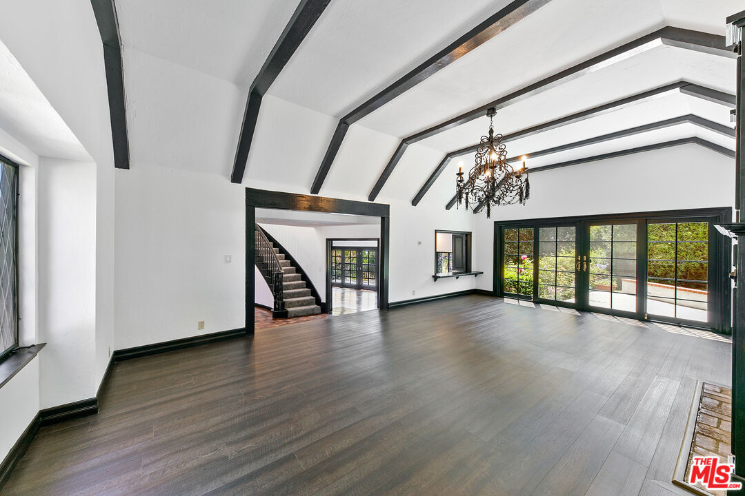 29528 Harvester Road Malibu, CA 90265 - Photo 9 of 36 a view of an empty room with wooden floor fireplace and a window