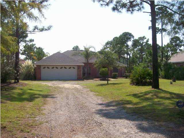 1364 Driftwood Point Road Santa Rosa Beach, FL 32459 - Photo 2 of 32 a house with trees in front of it