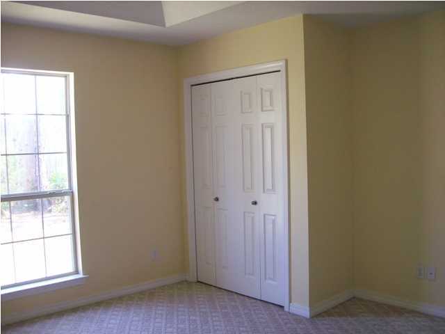 1364 Driftwood Point Road Santa Rosa Beach, FL 32459 - Photo 14 of 32 an empty room with wooden floor and windows