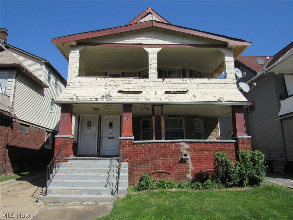 863 Eddy Road Cleveland, OH 44108 - Photo 1 of 28 Two-story structure with a red brick foundation, dual entry doors, and a double-tiered covered porch