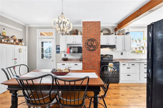 a view of a dining room with furniture and chandelier