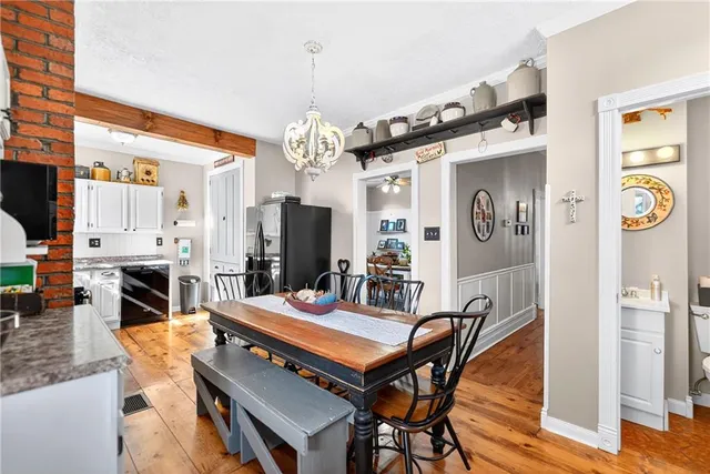 a outdoor dining space with furniture and a chandelier