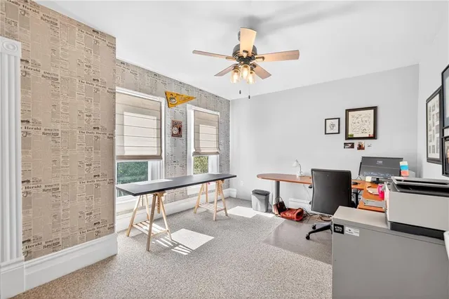 a living room with furniture and a floor to ceiling window