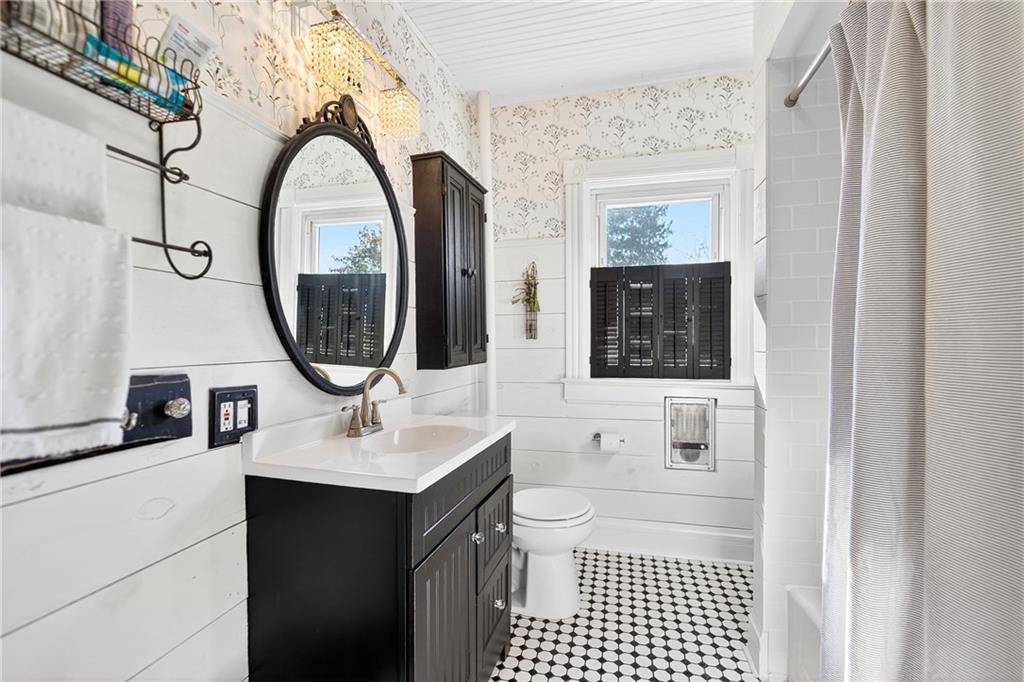 722 8th Street Irwin, PA 15642 - Photo 29 of 50 a bathroom with a sink a mirror and a shower