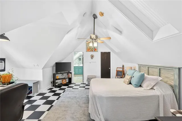 a bedroom with a bed and a tv